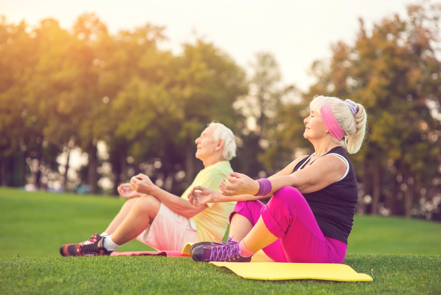 Elderly couple doing yoga.